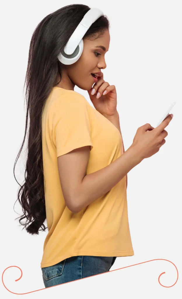 girl with headphones on, looking at her phone